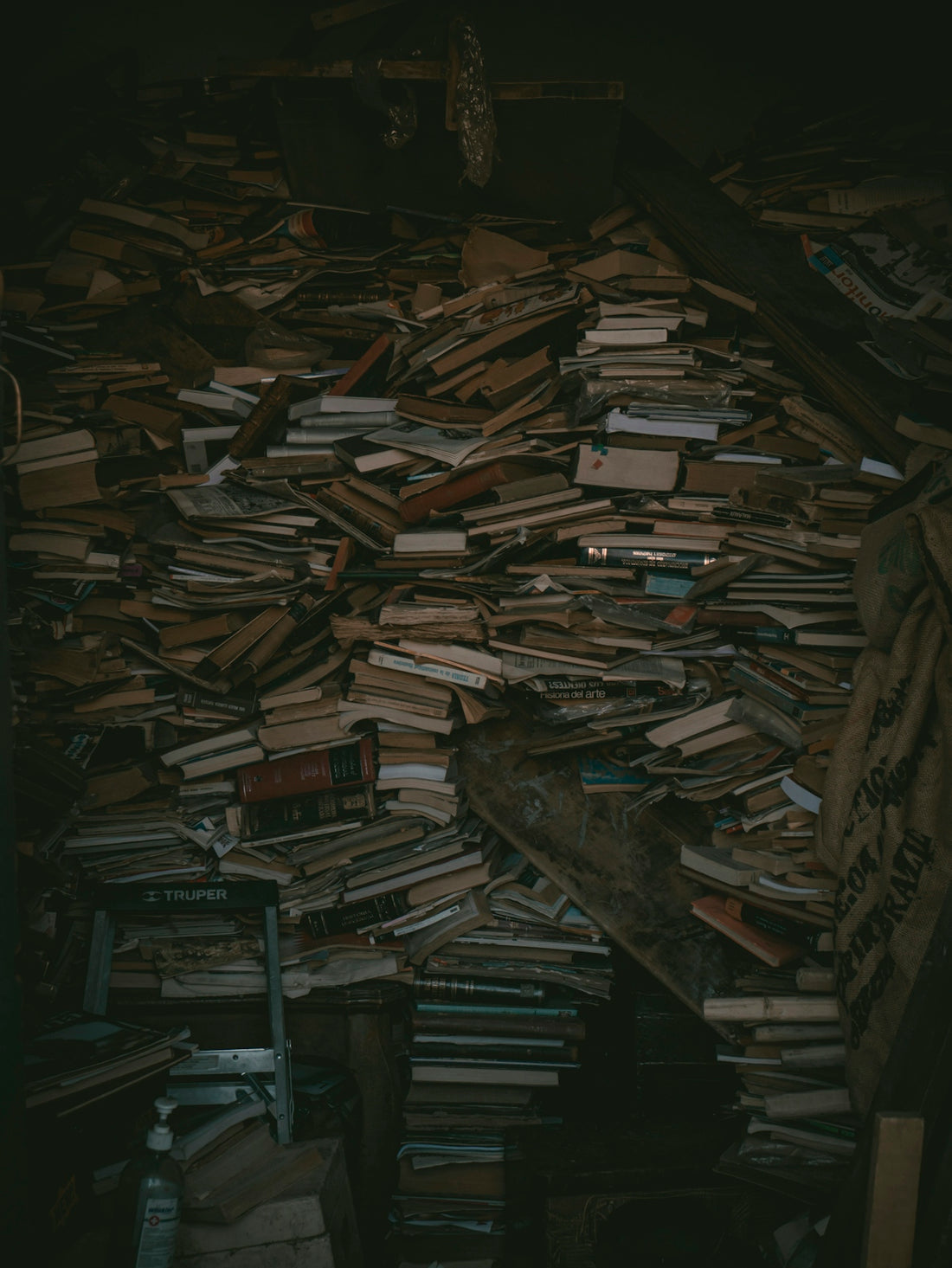 a pile of books sitting on top of a wooden floor